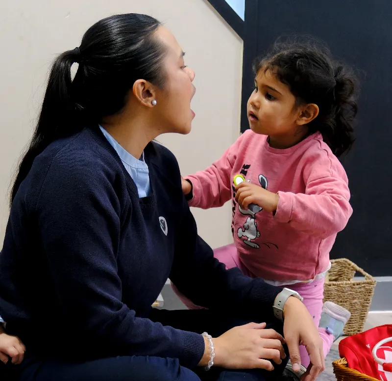 adult and child look at each other